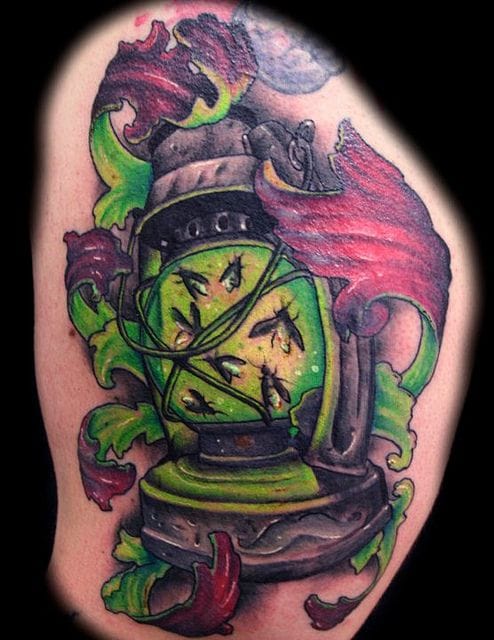 a beautiful firefly tattoo with lantern detail