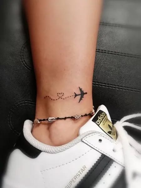 airplane on ankle tattoo