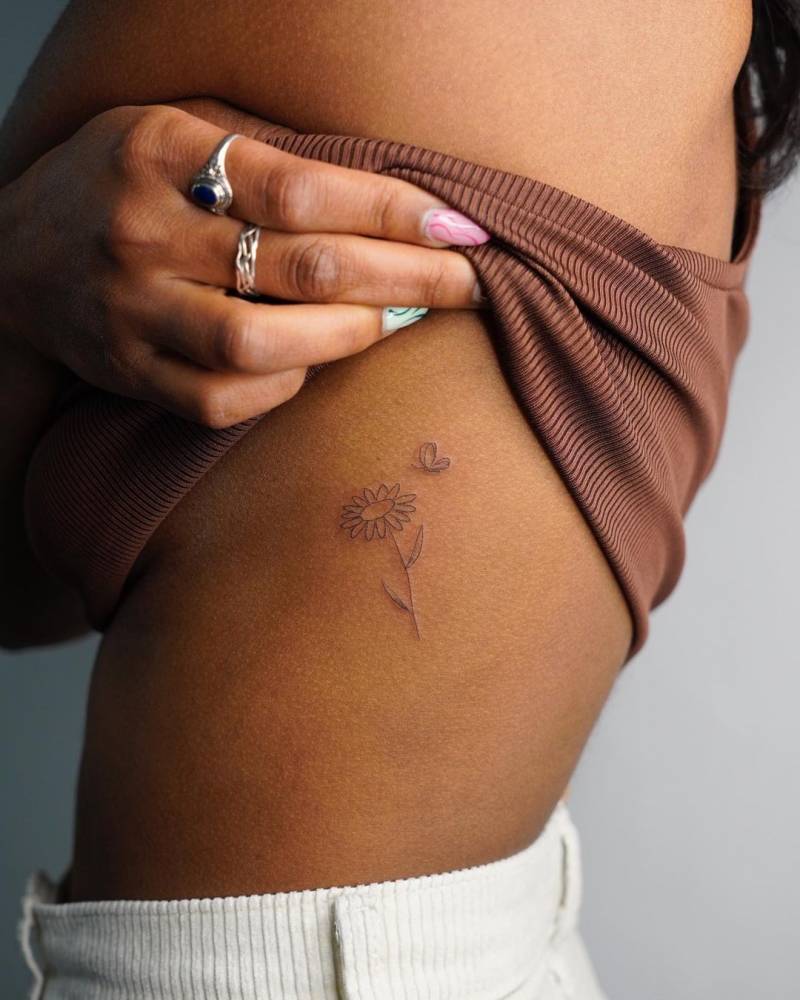 rib daisy tattoo