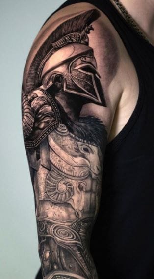 a muscular upper arm tattoo with spartan helmet