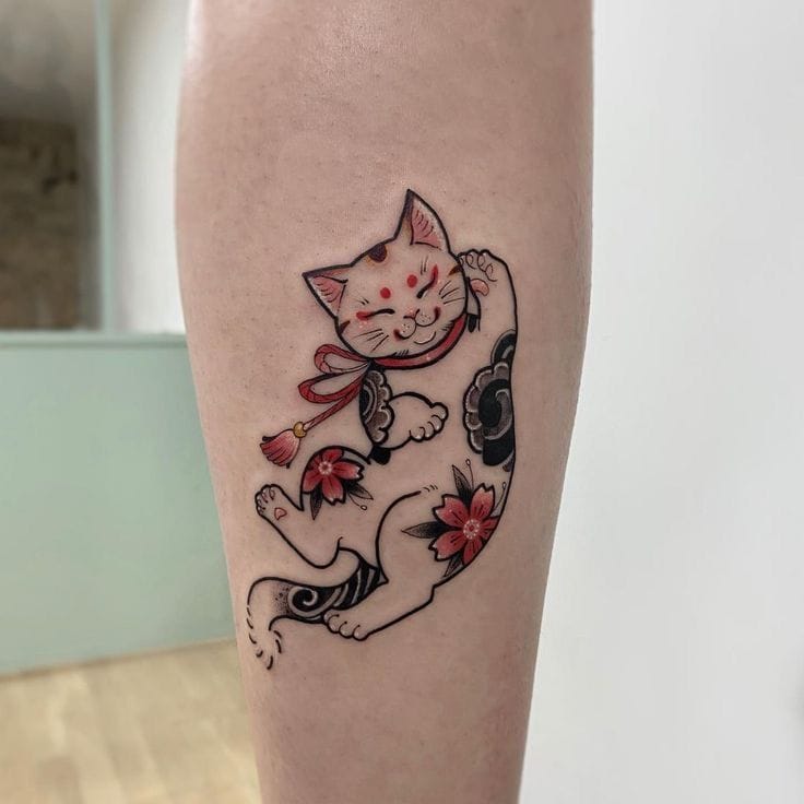 a small Japanese tattoo with a cat