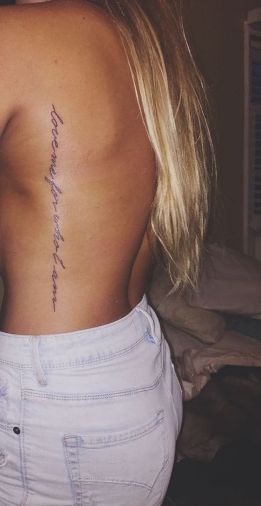 a minimalist ribs tattoo with quote in straight line