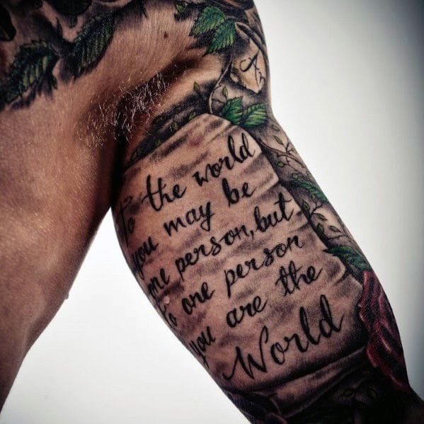 a man's upper arm tattoo with quote