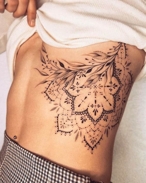 a cool ribs tattoo with geometric mandala