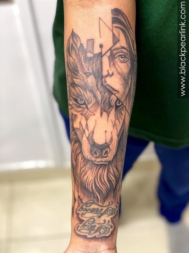 upper arm with wolf tattoo in tribal geometric style