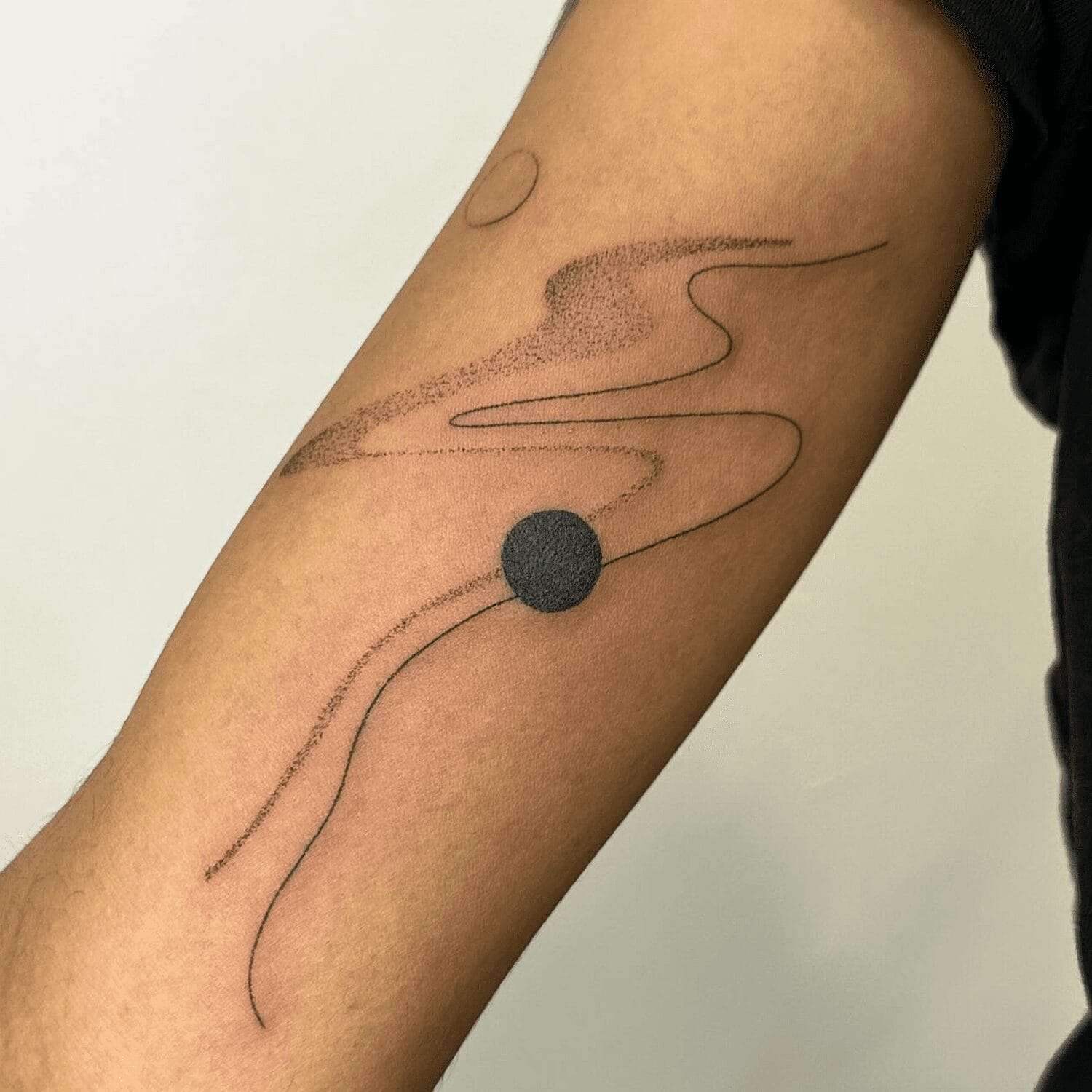 a minimalist upper arm tattoo with simple lines