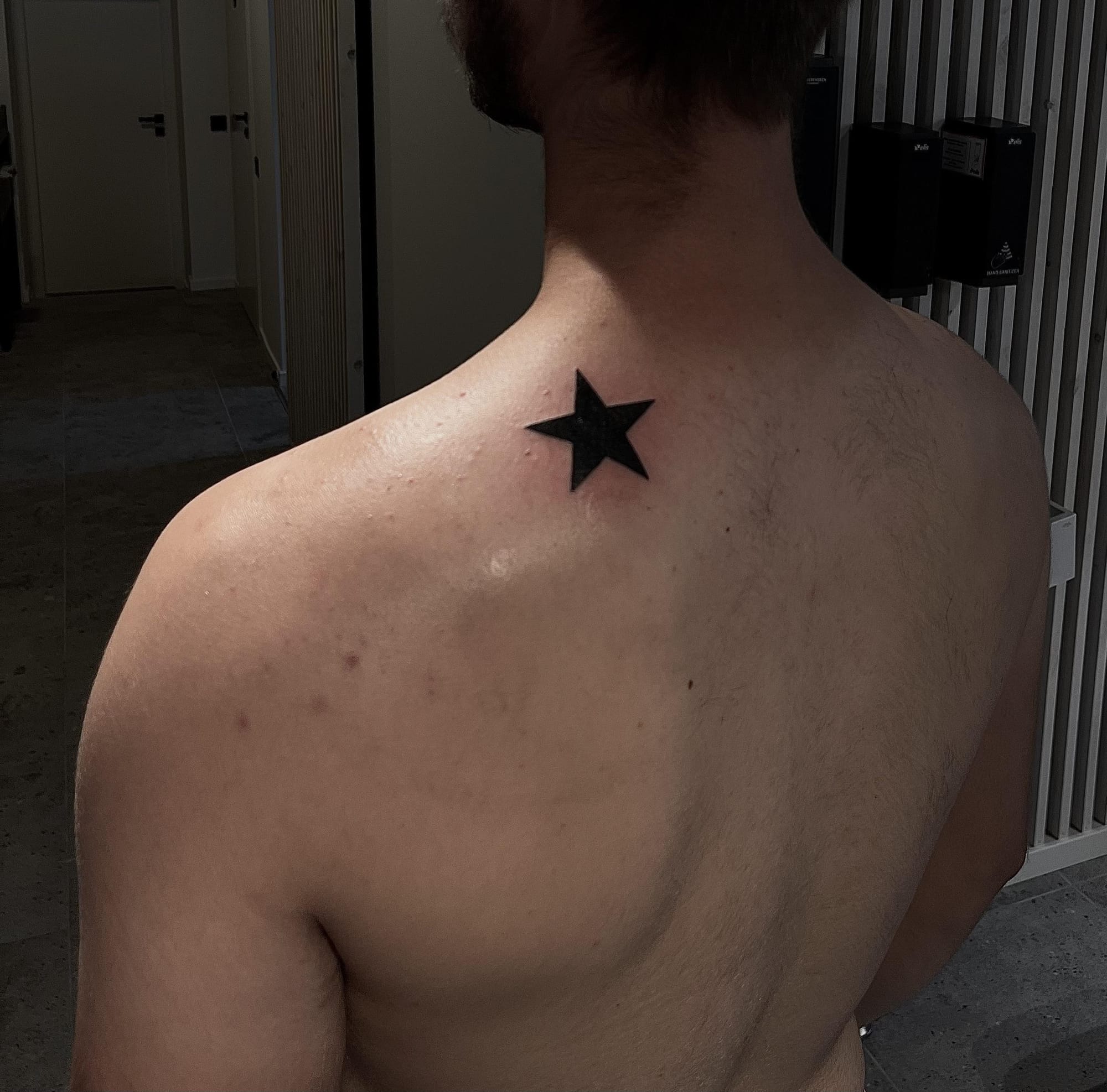 realistic black star tattoo