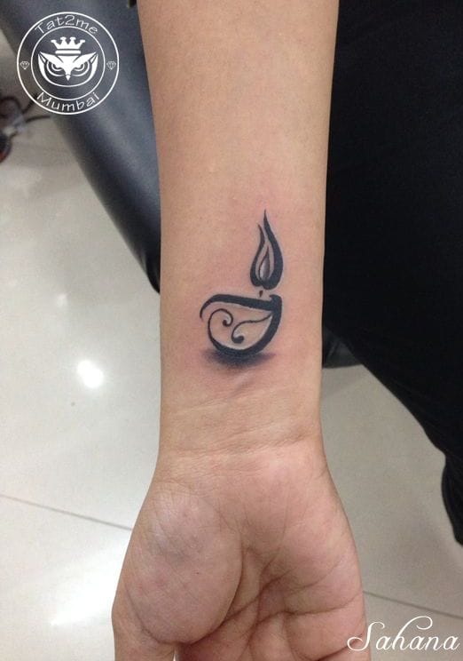 an Indian tattoo with a diya lamp
