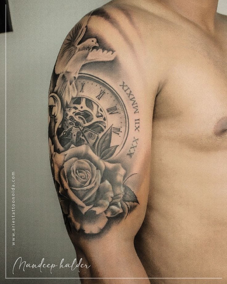 a muscular upper arm tattoo with compass rose