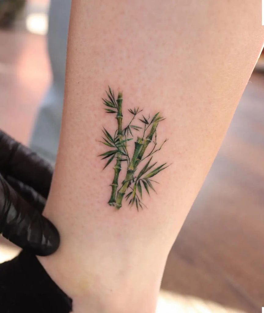 a small Japanese tattoo with a bamboo stalk