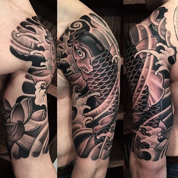 an upper arm tattoo with Japanese koi