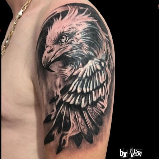 an upper arm tattoo with eagle design