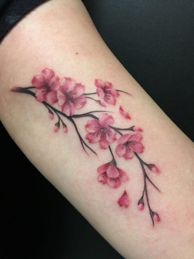 a small Japanese tattoo with cherry blossoms