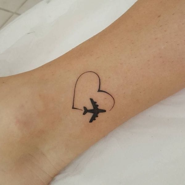 airplane flying through heart tattoo