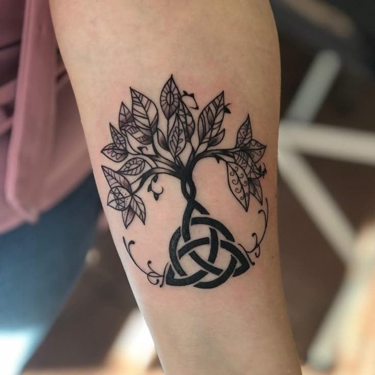 upper arm with tree of life tattoo in celtic knot style