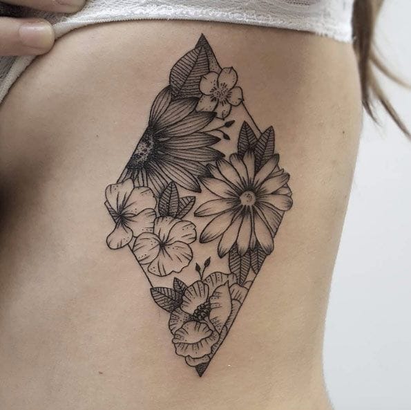 a shaded diamond ribs tattoo on woman