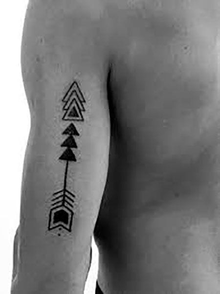 a/an upper arm tattoo with simple arrow