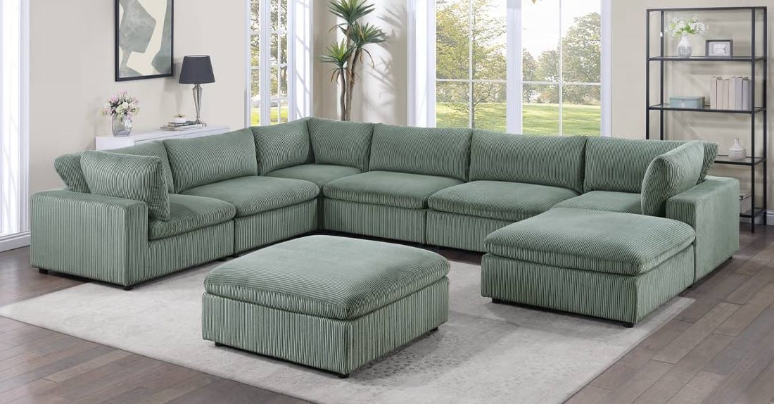 living room with sage green velvet modular sectional with ottoman and metal legs