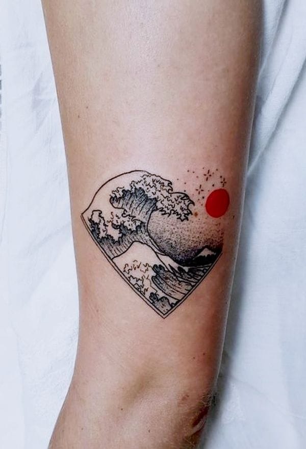 a small Japanese tattoo with a wave