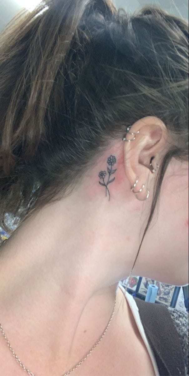 behind ear daisy tattoo
