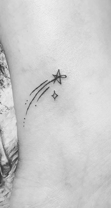 a simple shooting star tattoo silhouette design
