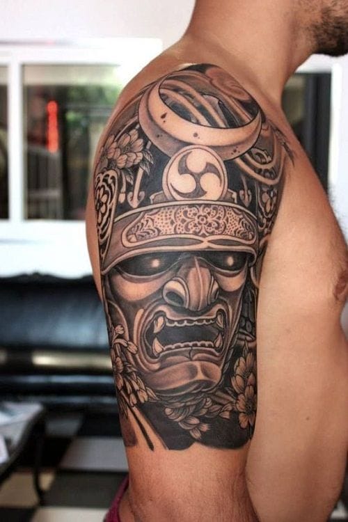 a muscular upper arm tattoo with samurai mask