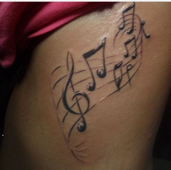 a rib tattoo with a music note staff