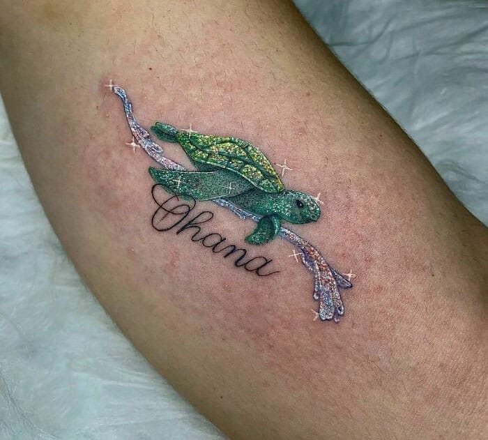 a dazzling glitter tattoo with a word