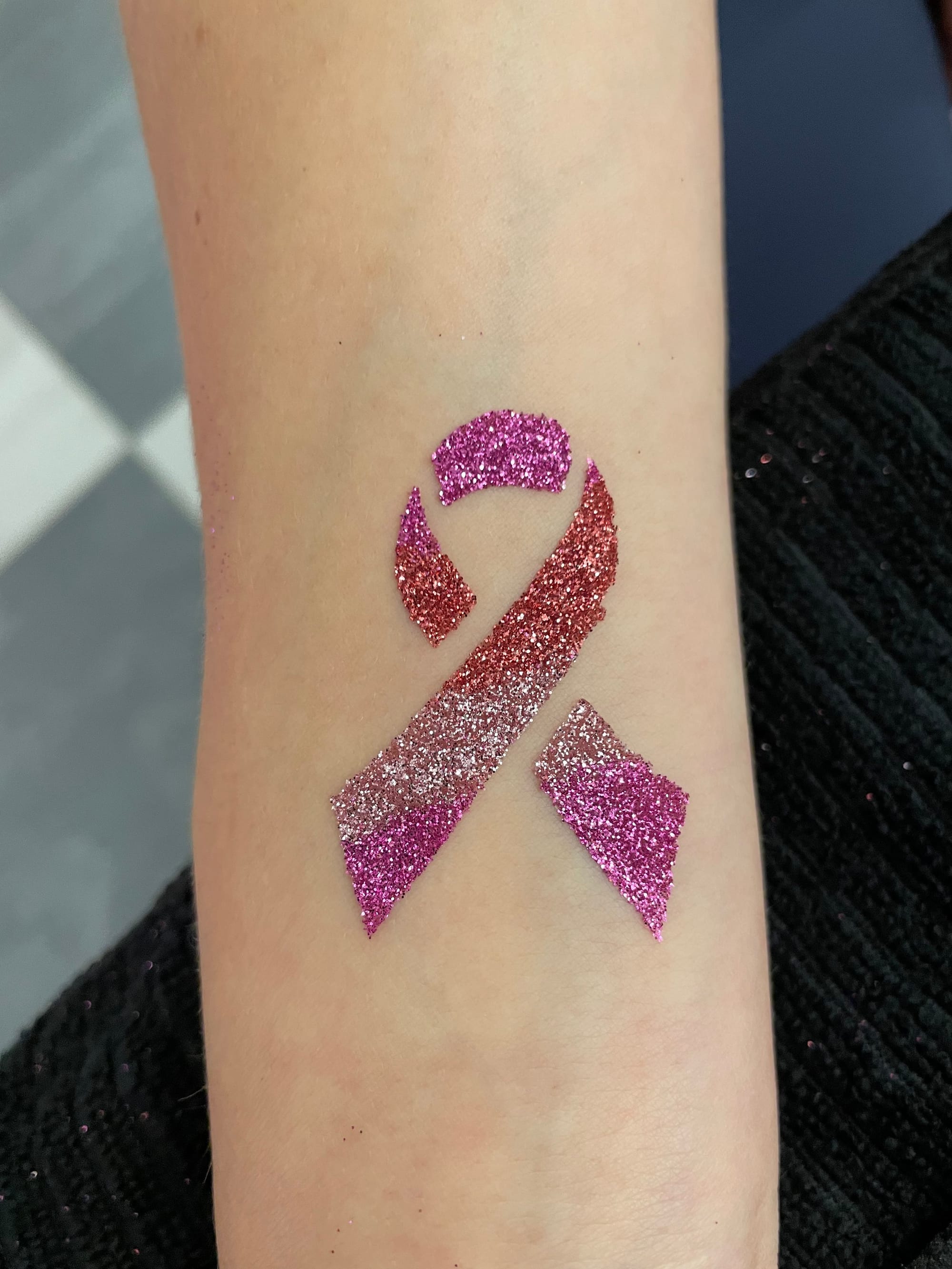 a dazzling glitter tattoo with glitter ribbon
