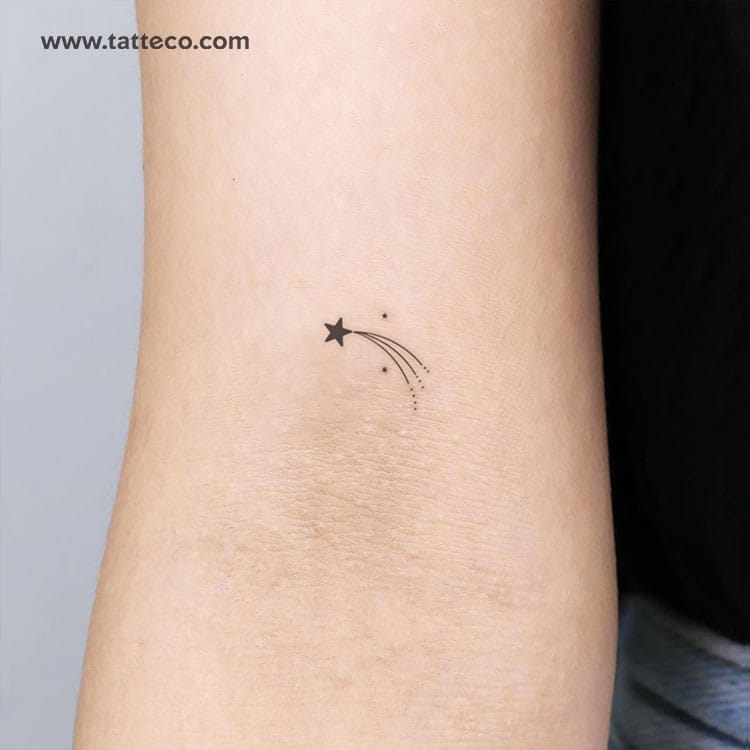 a shooting star tattoo with tiny stars