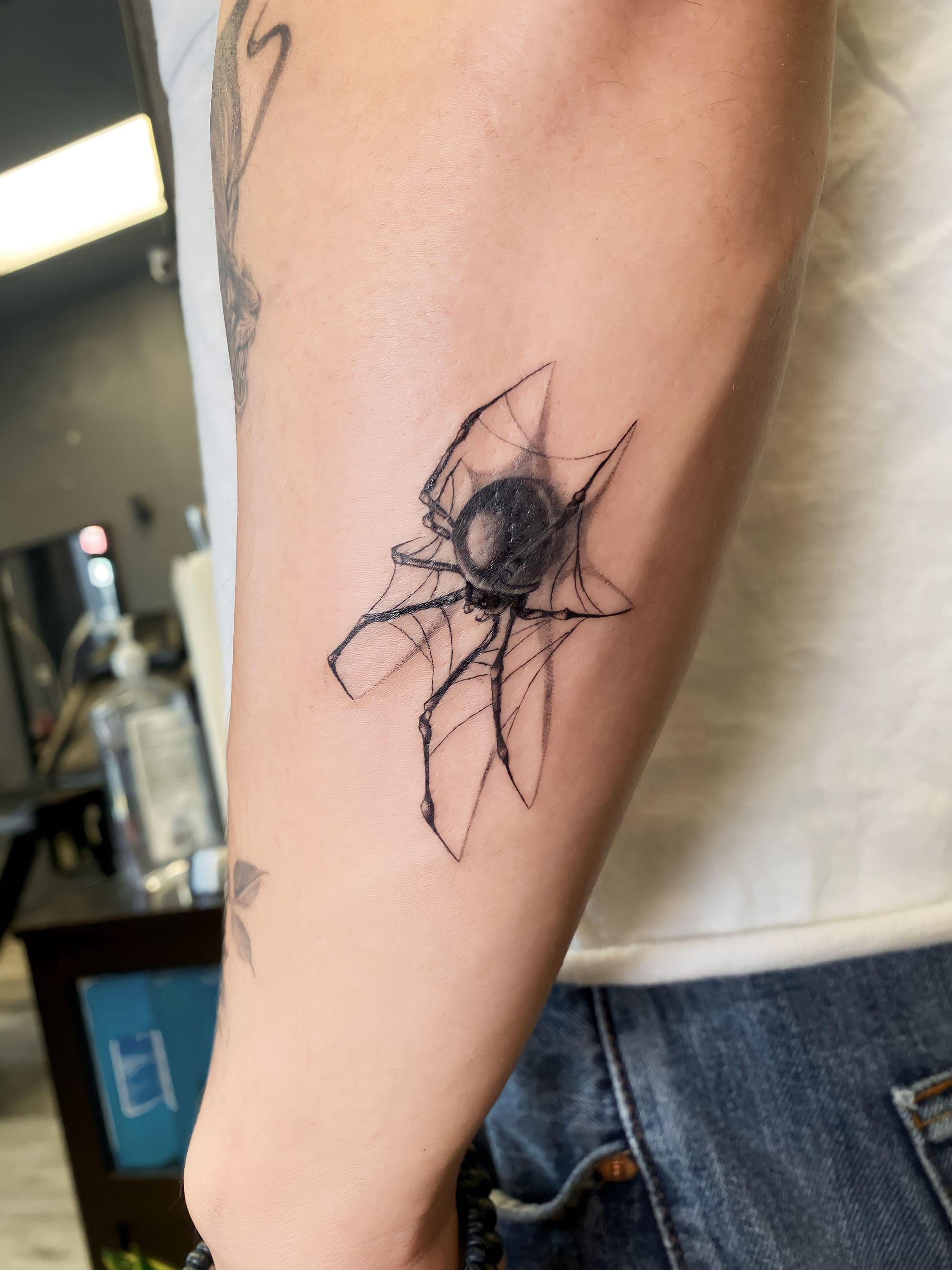 arm spider tattoo