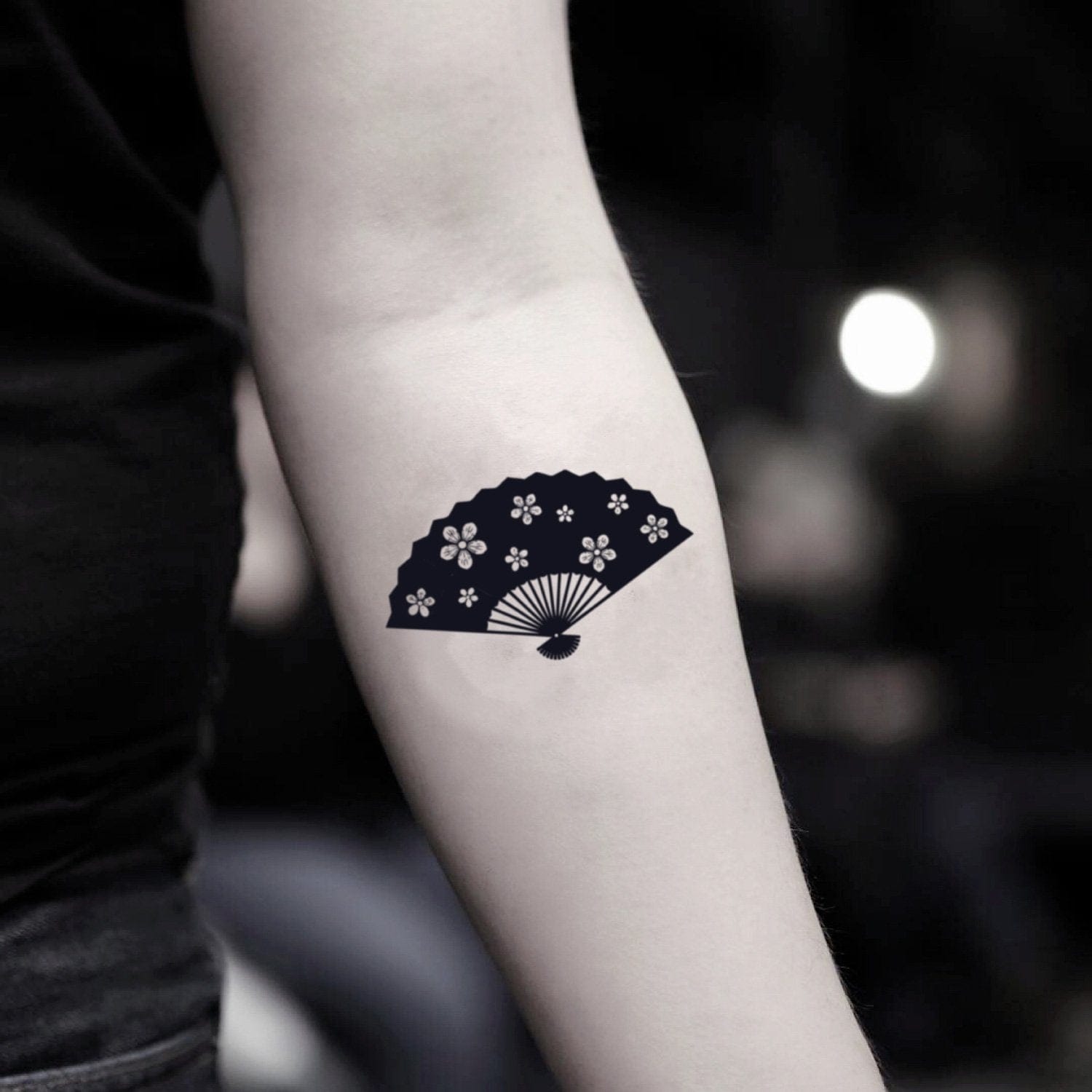 a small Japanese tattoo with a fan