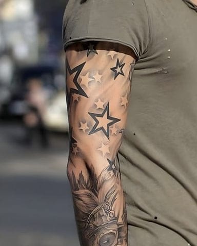 a masculine upper arm tattoo with nautical star