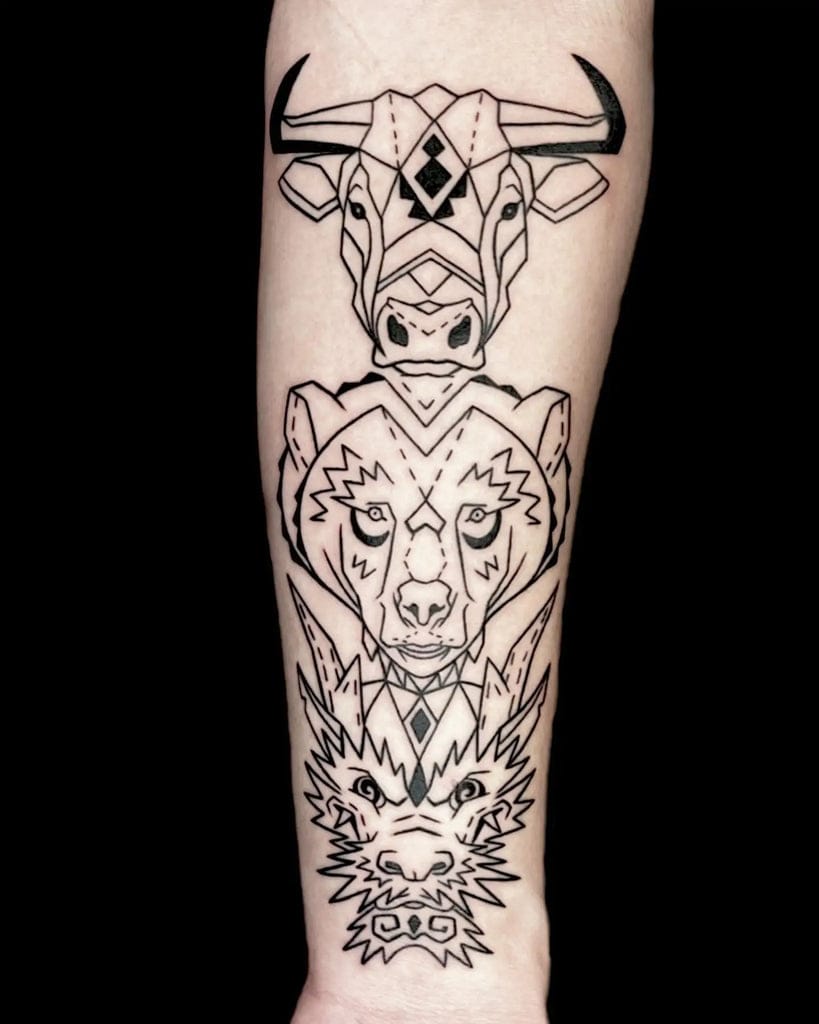 upper arm with animal totem tattoo in geometric style