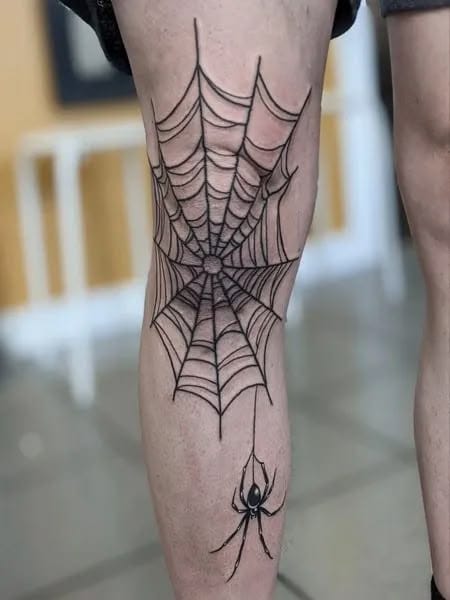 spiderweb knee tattoo