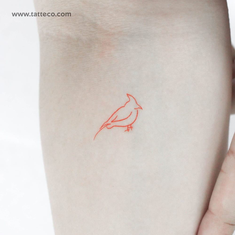 Delicate red linework transforms a simple cardinal into pure poetry on skin 🕊️ The minimalist outline captures the bird's essence with just a few graceful strokes, proving that sometimes the most powerful tattoos whisper rather than shout. Perfectly sized for subtle placement, this design celebrates both the cardinal's symbolism of hope and the beauty of restraint in tattoo artistry.
