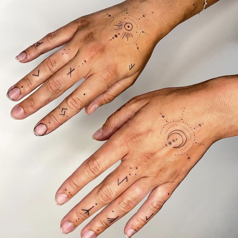 Celestial magic flows across both hands in this enchanting matching tattoo set, featuring sun and moon motifs surrounded by delicate dotwork constellations. The minimalist line work creates an ethereal, mystical aesthetic that's perfect for those who want to carry cosmic energy with them everywhere ✨ Such a beautiful way to symbolize balance and duality!