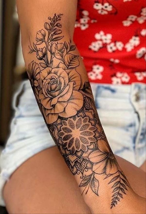 Delicate botanicals cascade down this forearm in perfect harmony, featuring an intricate rose paired with geometric mandala elements and wispy fern fronds. The fine line work and detailed shading create stunning depth while maintaining an elegant, feminine aesthetic that flows beautifully with the arm's natural contours 🌿