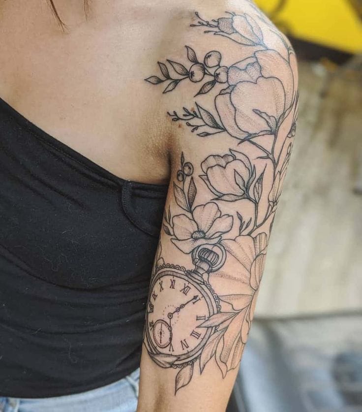 Delicate florals dance alongside the timeless symbolism of a vintage pocket watch in this stunning half-sleeve masterpiece. The intricate line work seamlessly blends botanical elements with Roman numerals, creating a beautiful narrative about life's fleeting moments and natural beauty 🌸 Perfect placement on the arm allows each element to flow gracefully from shoulder to elbow.