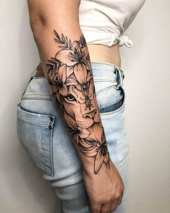 Botanical elegance meets fierce femininity in this stunning forearm piece that seamlessly blends a lioness portrait with delicate floral elements. The intricate linework creates beautiful contrast between the powerful feline features and soft peony blooms, while the strategic placement allows the design to flow naturally with the arm's curves. A perfect choice for anyone wanting to embody both strength and grace 🌸