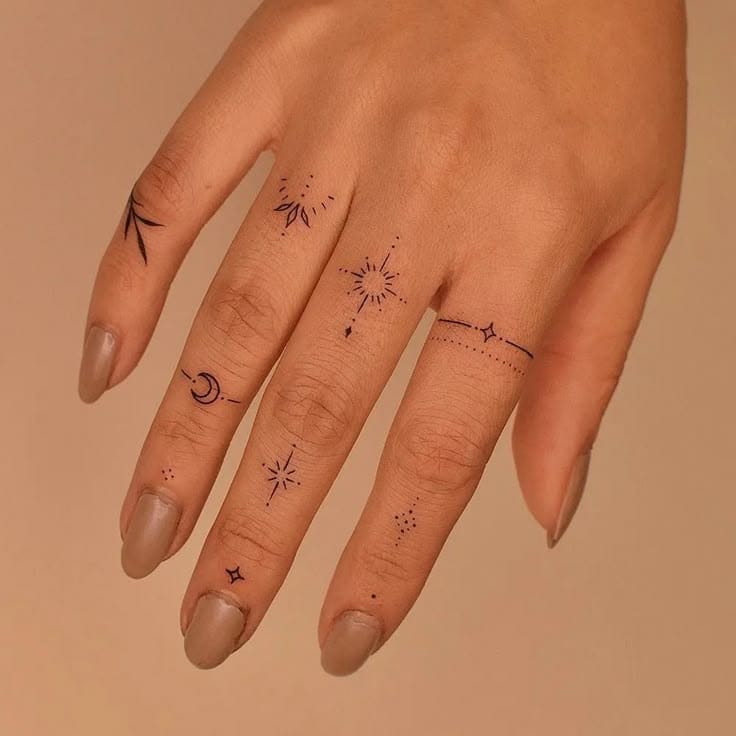 Delicate celestial symbols dance across each finger in this enchanting hand tattoo collection ✨ From crescent moons to radiating stars and dotted constellations, each digit tells its own cosmic story while creating a unified celestial narrative. The fine line work and strategic placement transform everyday hand gestures into magical displays of astronomical artistry.