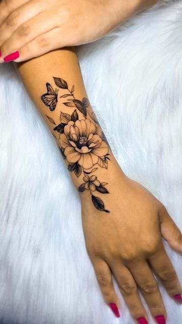 Delicate botanical artistry flows down the forearm like nature's own masterpiece, featuring an intricate butterfly dancing among blooming peonies and trailing leaves. The fine line work and elegant placement create a stunning sleeve effect that wraps beautifully around the arm, while the contrast between the detailed florals and graceful butterfly adds layers of symbolic meaning about transformation and growth 🦋