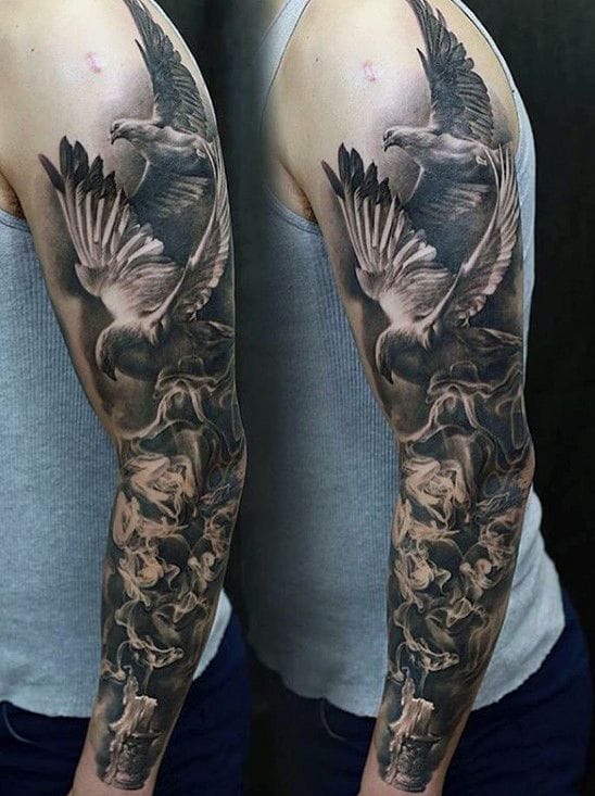 Breathtaking realism meets nature's raw power in this full sleeve masterpiece featuring a majestic eagle in flight surrounded by delicate roses. The artist's incredible attention to detail brings every feather and petal to life, creating a stunning contrast between the bird's fierce strength and the flowers' soft beauty. This black and grey composition flows seamlessly from shoulder to wrist, proving that wildlife tattoos can be both bold and elegant 🦅