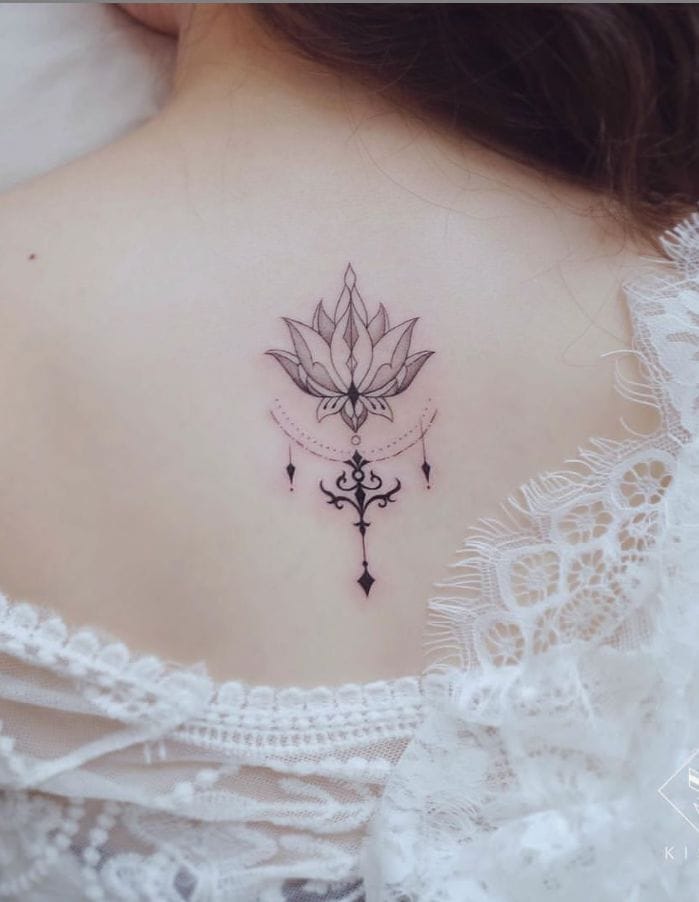 Delicate linework transforms into pure artistry with this stunning lotus mandala cascading down the spine, where geometric petals bloom above ornate chandelier-style details that seem to dance with every movement. The precise dotwork and flowing curves create a mesmerizing vertical composition that's both spiritually symbolic and visually striking 🪷 Perfect placement for a design that deserves to be the centerpiece!