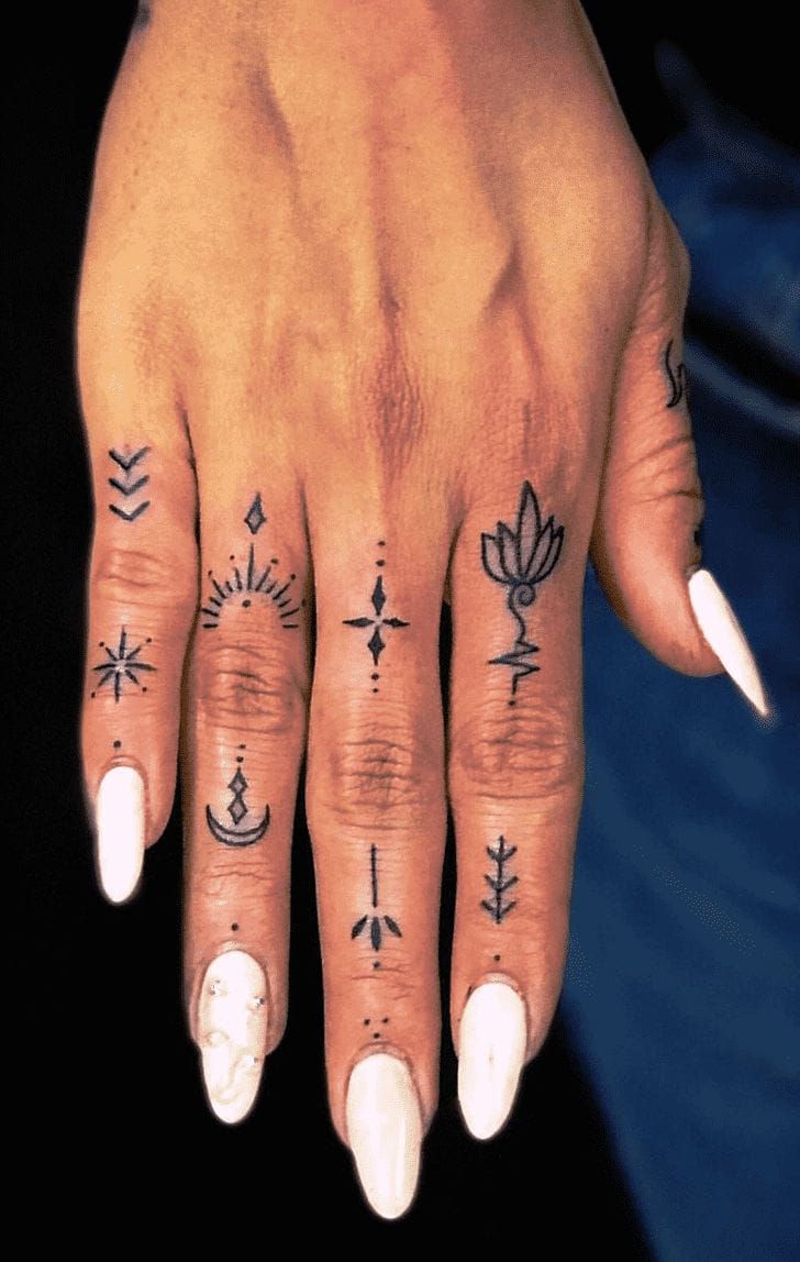 Delicate mystical symbols dance across each finger in this enchanting hand tattoo collection, featuring celestial motifs like stars, crescents, and botanical elements that create a bohemian spell. The minimalist black ink work transforms the fingers into a living tarot deck, with each digit telling its own spiritual story through carefully placed geometric and nature-inspired designs. ✨