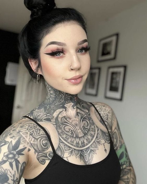 Intricate mandala artistry cascades from neck to chest in this stunning blackwork masterpiece, creating an almost armor-like effect with its detailed geometric patterns and flowing organic elements. The bold placement transforms the entire upper torso into a canvas of symmetrical beauty, while the precise linework and shading demonstrate exceptional technical skill ✨