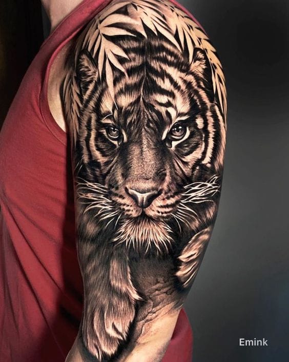 Masterful black and gray realism brings this majestic tiger to life on an impressive half-sleeve canvas, with every whisker and stripe rendered in stunning detail. The artist's exceptional shading technique creates incredible depth and dimension, making the tiger's intense gaze practically leap off the skin 🐅 Pure artistry that showcases both the wearer's bold spirit and the tattoo artist's incredible skill.
