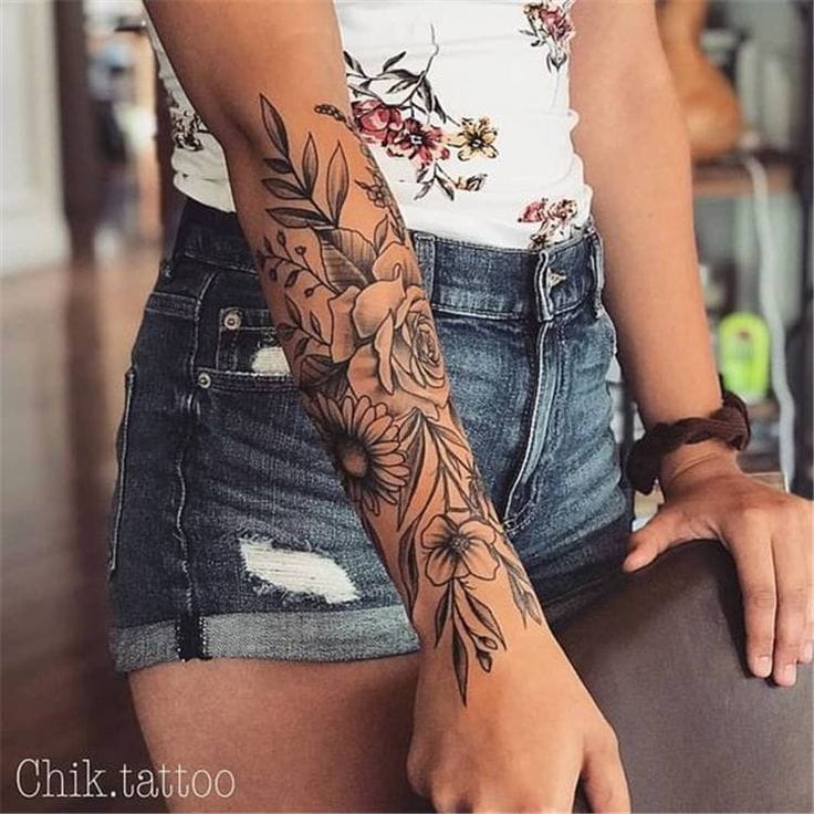Botanical artistry cascades down this forearm like nature's own masterpiece, featuring delicate roses intertwined with graceful leaves and flourishing florals. The intricate linework creates stunning depth and movement, making this feminine sleeve a perfect blend of elegance and edge 🌹 Pure tattoo goals for anyone dreaming of a sophisticated floral piece!