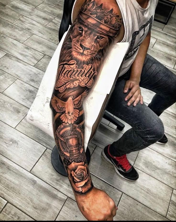 Majestic royalty meets intricate artistry in this breathtaking full-leg sleeve featuring a crowned lion as the centerpiece. The detailed script work reading 