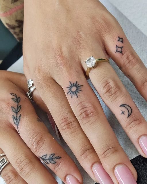 Delicate finger tattoos transform hands into a celestial map, featuring a radiant sun, crescent moon, twinkling stars, and botanical elements that flow naturally across the knuckles and digits. The fine line work creates an enchanting constellation of meaningful symbols, while the strategic placement allows each design to complement the hand's natural movement ✨ Perfect for those who want to carry a piece of the cosmos wherever they go.